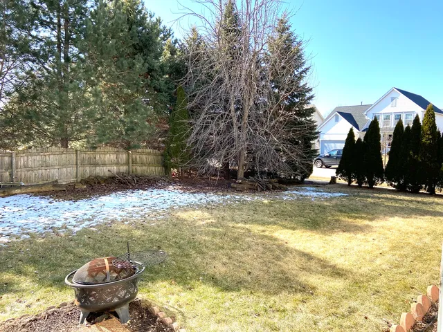 a view of a backyard with swimming pool