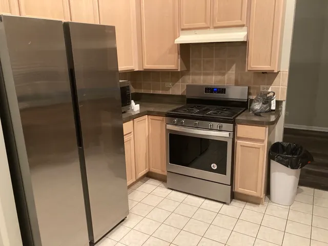 a kitchen with a stove and a refrigerator