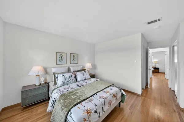 a bedroom with a bed and a lamp