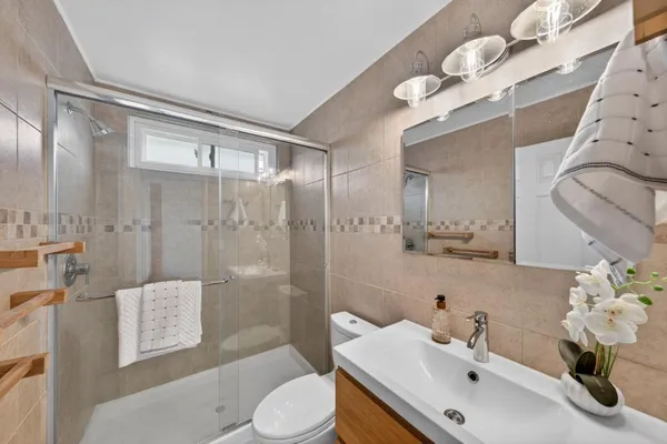 a bathroom with a sink toilet and shower