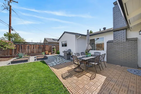 a view of a house with backyard and sitting area