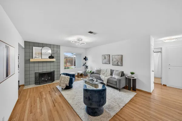 a living room with furniture and fireplace