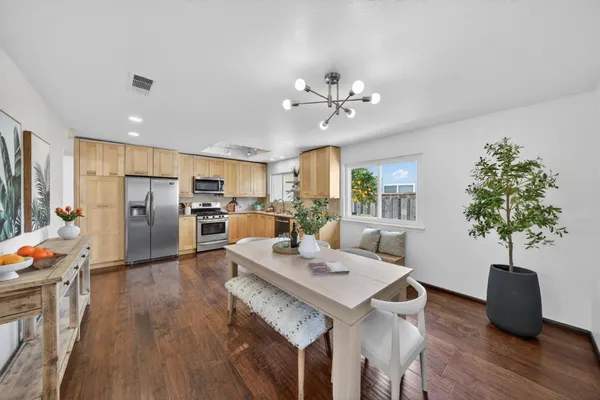 a view of a dining room with furniture window and wooden floor