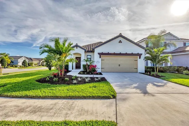 a front view of a house with a yard and garage