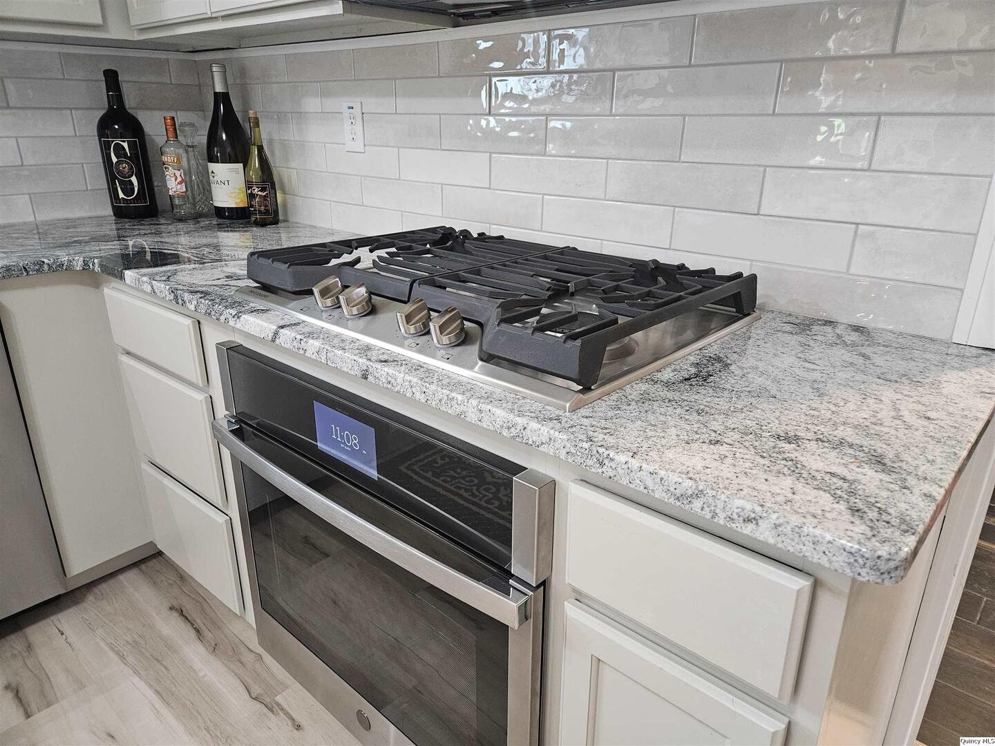306 Walker Street Ursa, IL 62376 - Photo 11 of 20 a stove top oven sitting inside of a kitchen