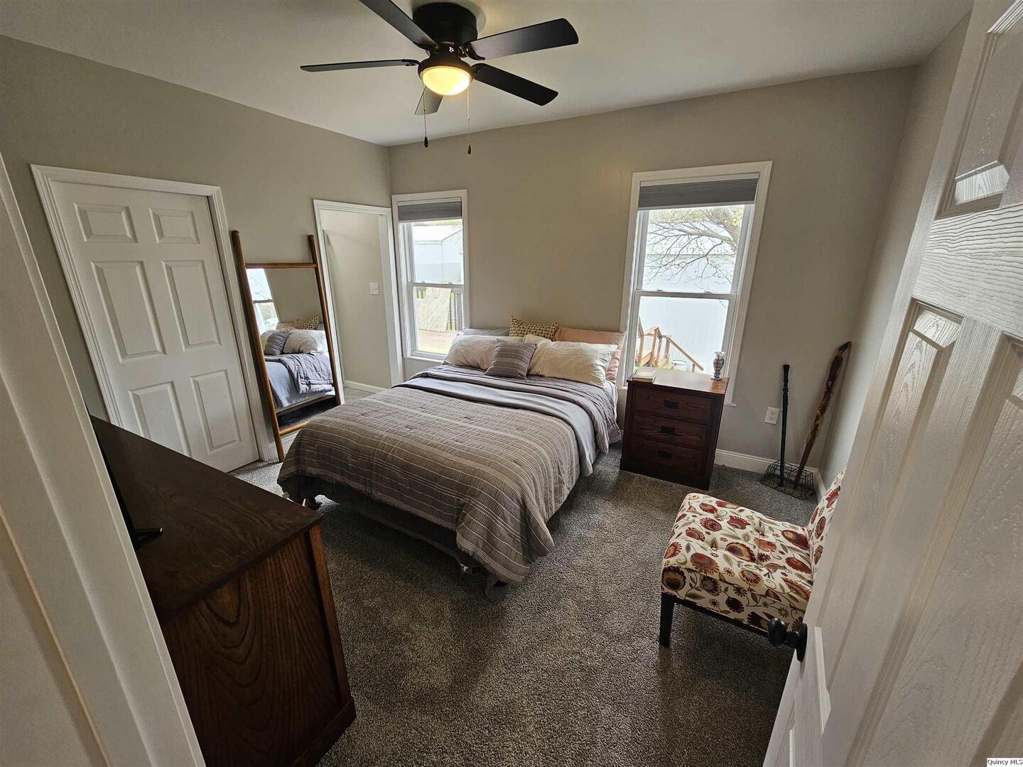 306 Walker Street Ursa, IL 62376 - Photo 17 of 20 a bedroom with a bed and a mirror