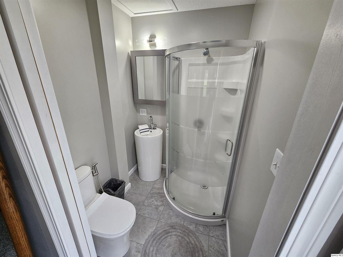 306 Walker Street Ursa, IL 62376 - Photo 18 of 20 a bathroom with a granite countertop toilet and a sink