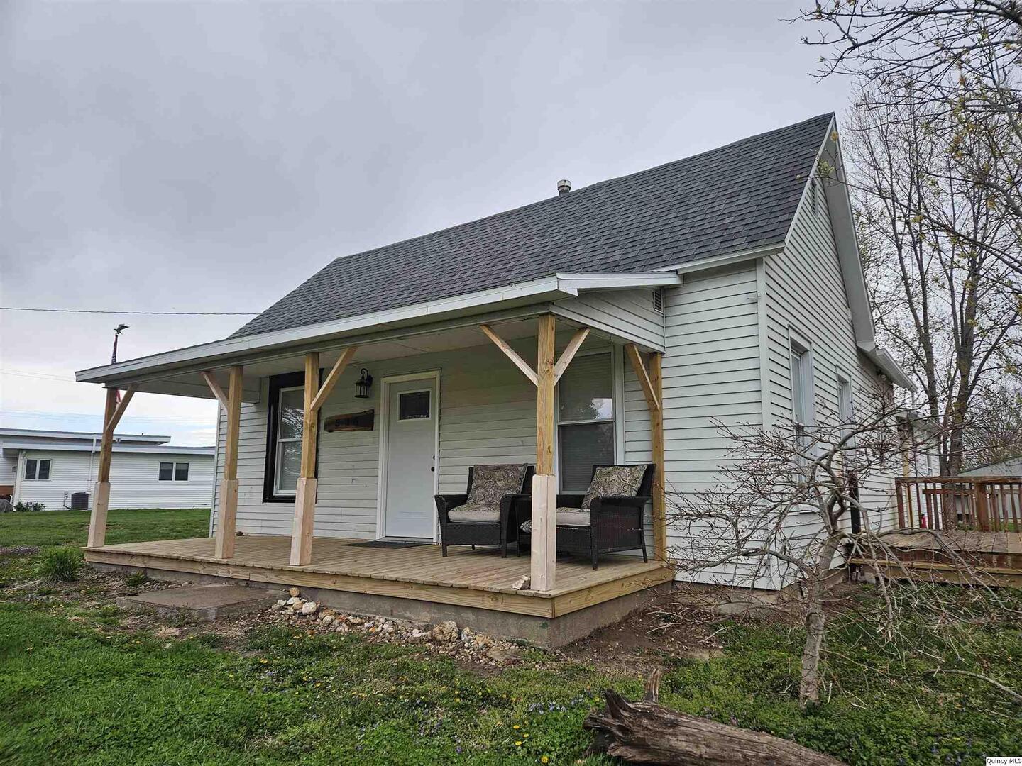 306 Walker Street Ursa, IL 62376 - Photo 3 of 20 a front view of a house with a yard