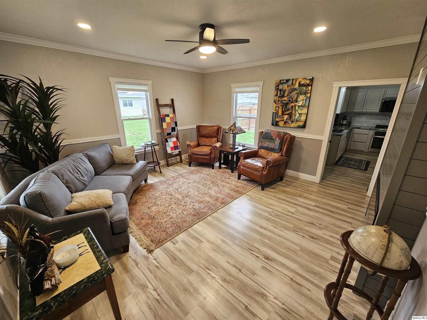 306 Walker Street Ursa, IL 62376 - Photo 6 of 20 a living room with furniture ceiling fan and a rug