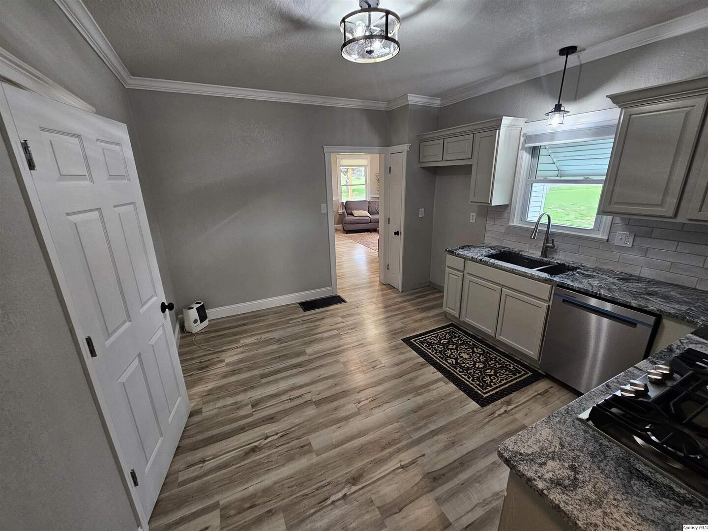 306 Walker Street Ursa, IL 62376 - Photo 10 of 20 a kitchen with granite countertop a stove and a sink