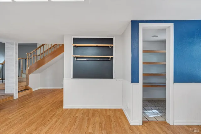 a view of a room with wooden floor and staircase