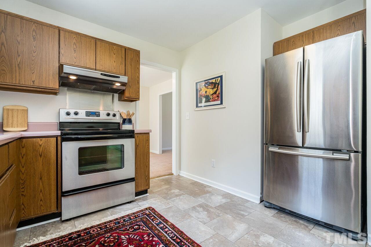 2 Halsey Place Durham, NC 27707 - Photo 13 of 27 a kitchen with granite countertop a stove top oven cabinets and stainless steel appliances