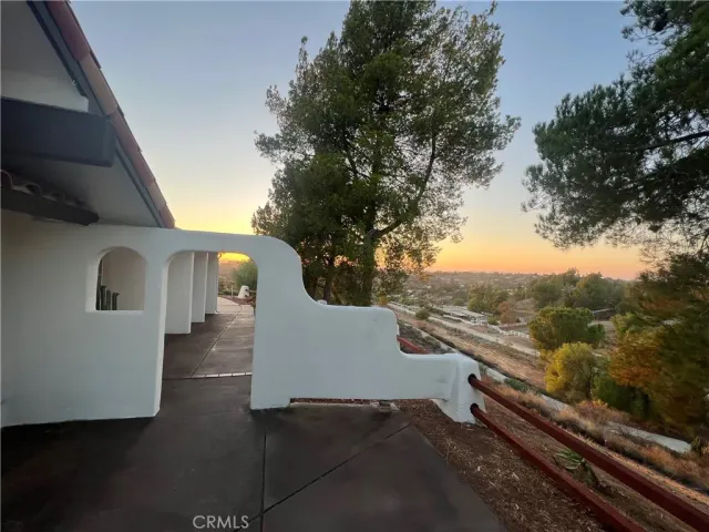 a backyard of a house with barbeque oven table and chairs