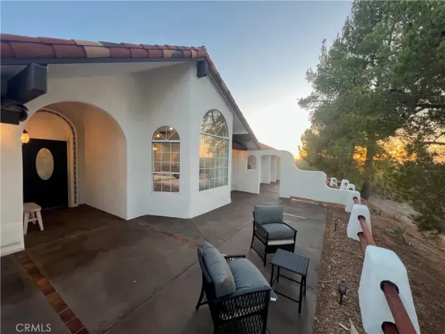 a living room with furniture and large windows