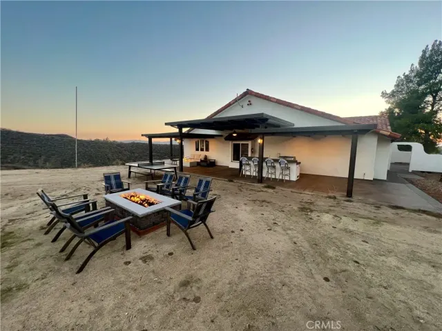 a view of a hallway with entryway wooden floor and a chandelier