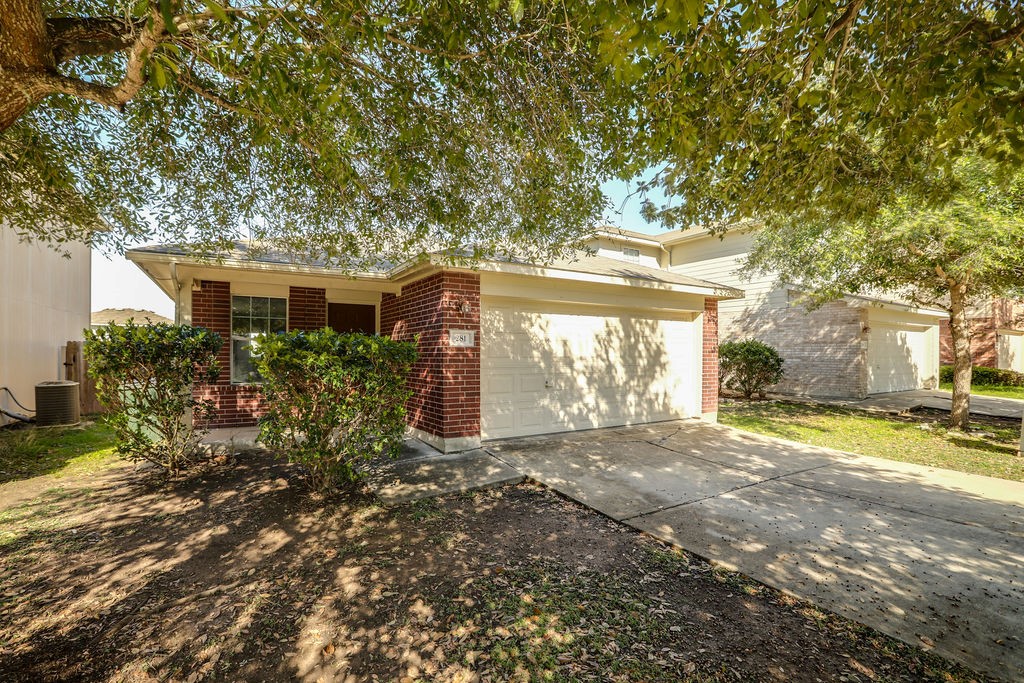 281 Jack Rabbit Lane Buda, TX 78610 - Photo 1 of 1 a front view of a house with a yard and garage
