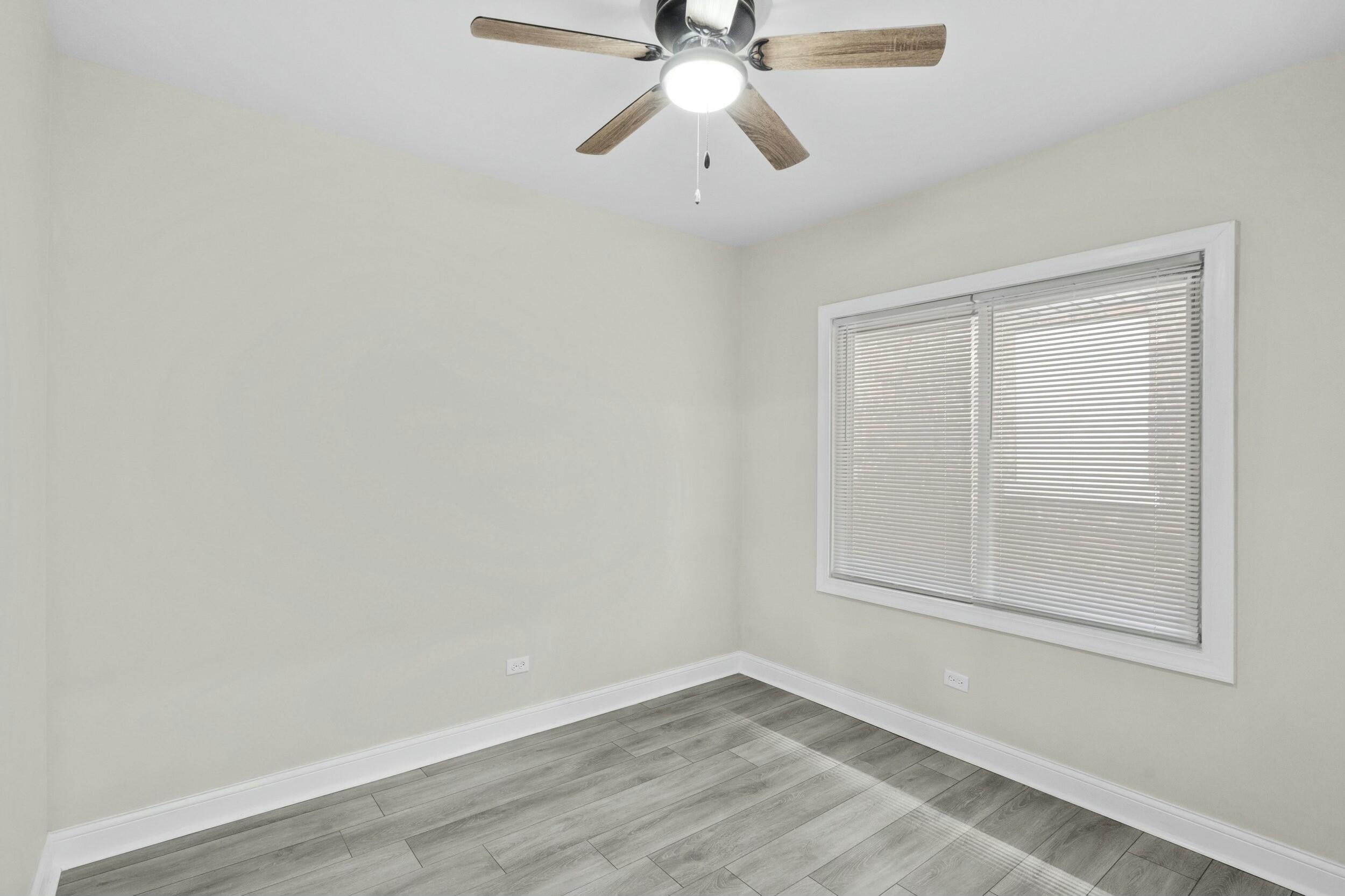 800 Garfield Street Gary, IN 46404 - Photo 14 of 23 a view of an empty room with wooden floor and a window