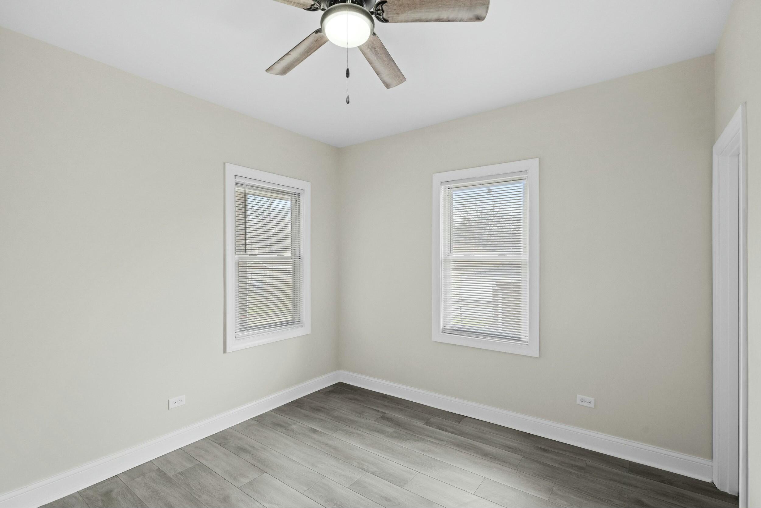 800 Garfield Street Gary, IN 46404 - Photo 15 of 23 a view of an empty room with a window and wooden floor