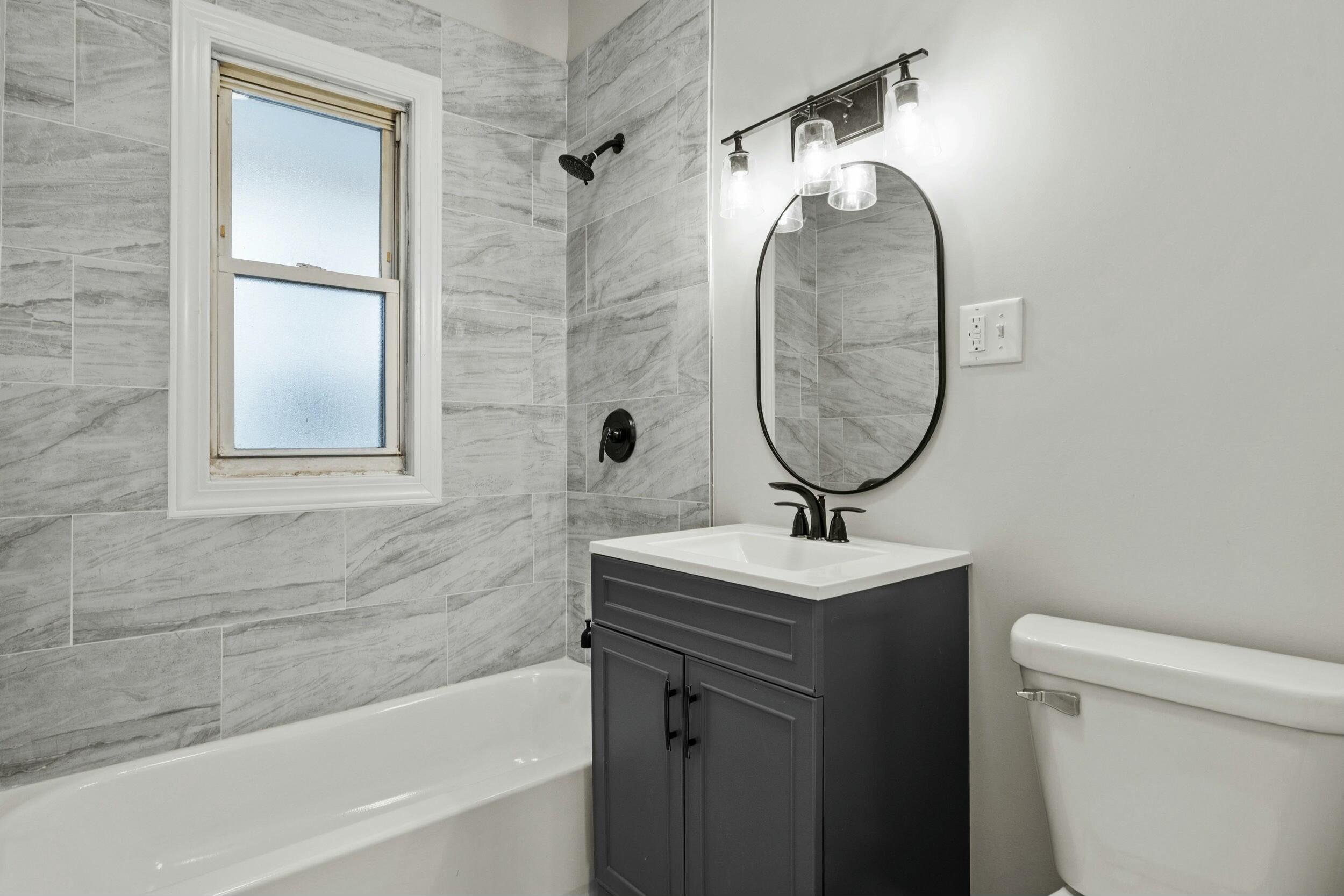 800 Garfield Street Gary, IN 46404 - Photo 16 of 23 a bathroom with a sink toilet and shower