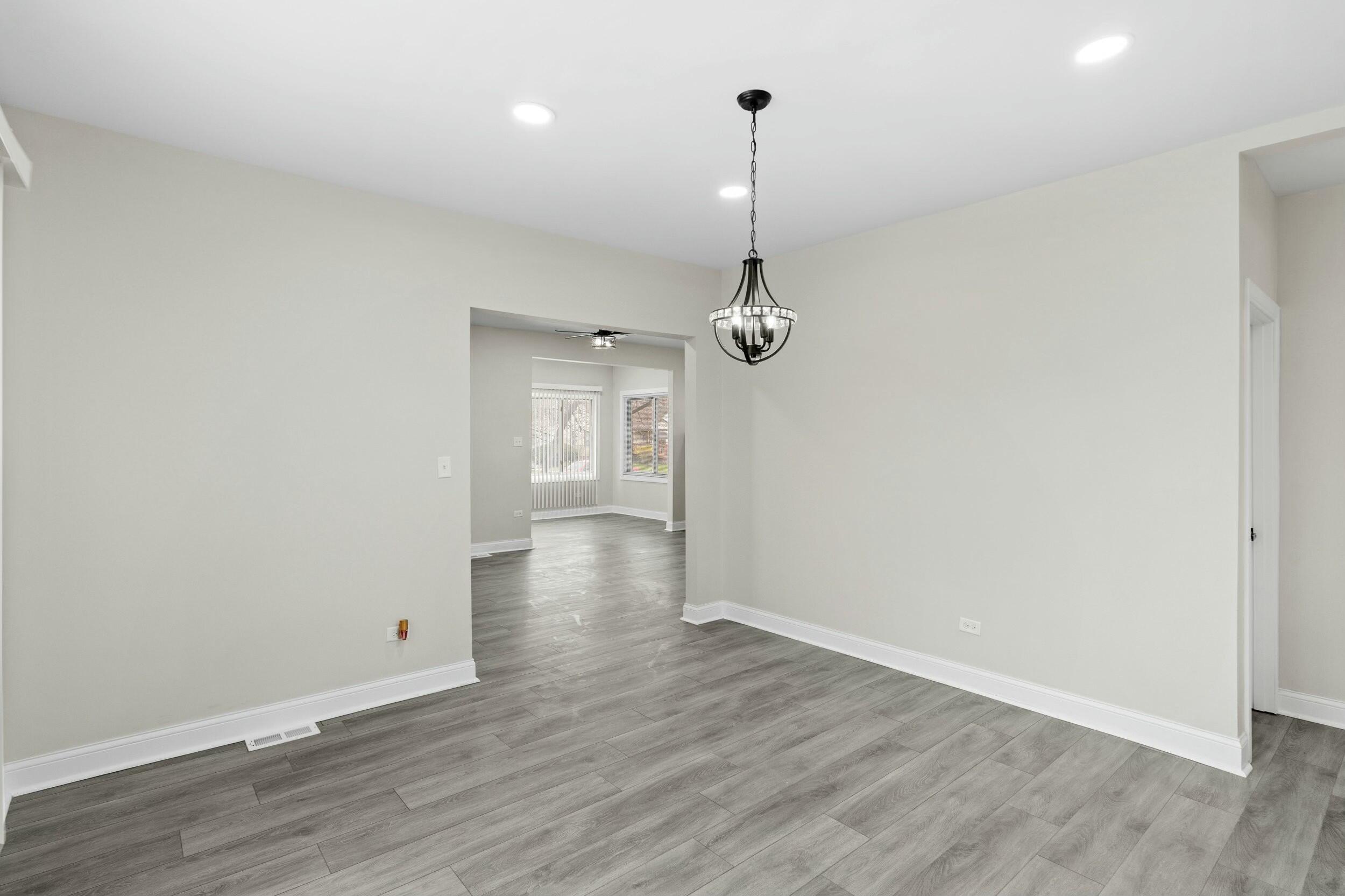 800 Garfield Street Gary, IN 46404 - Photo 9 of 23 a view of an empty room and a chandelier fan
