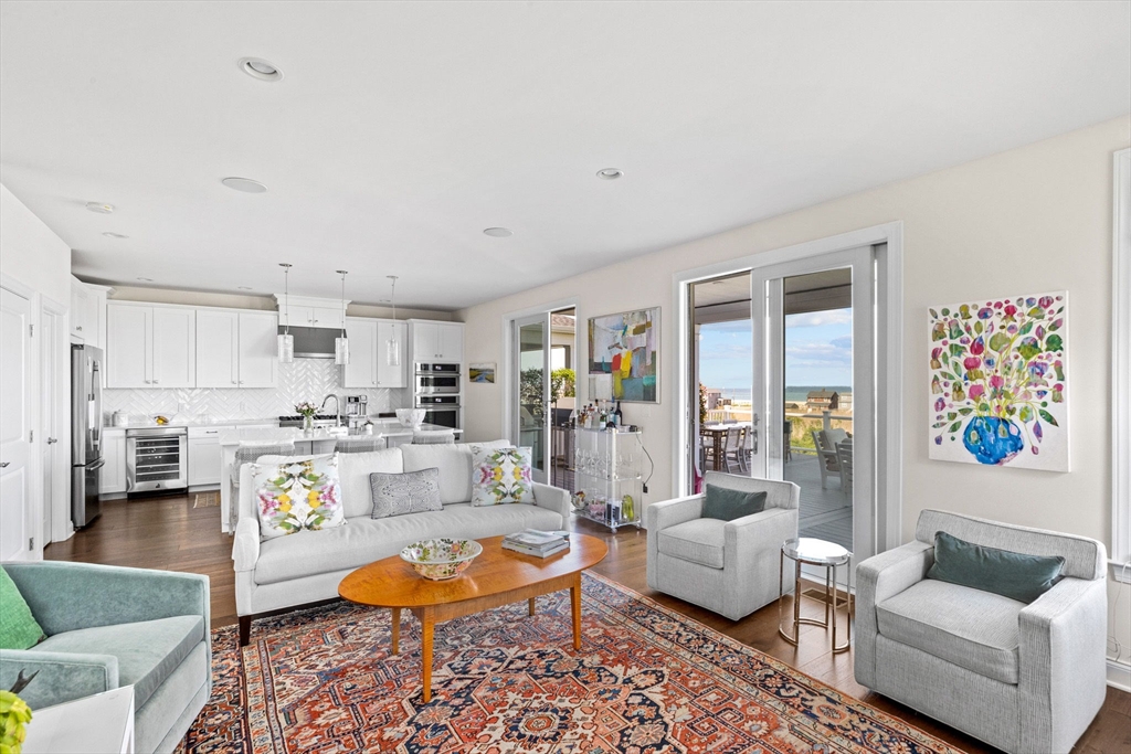 148 Hatherly Road, Unit 148 Scituate, MA 02066 - Photo 11 of 42 a living room with furniture and a dining table with kitchen view