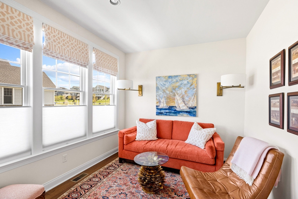 148 Hatherly Road, Unit 148 Scituate, MA 02066 - Photo 15 of 42 a blue couch sitting in a living room next to a window