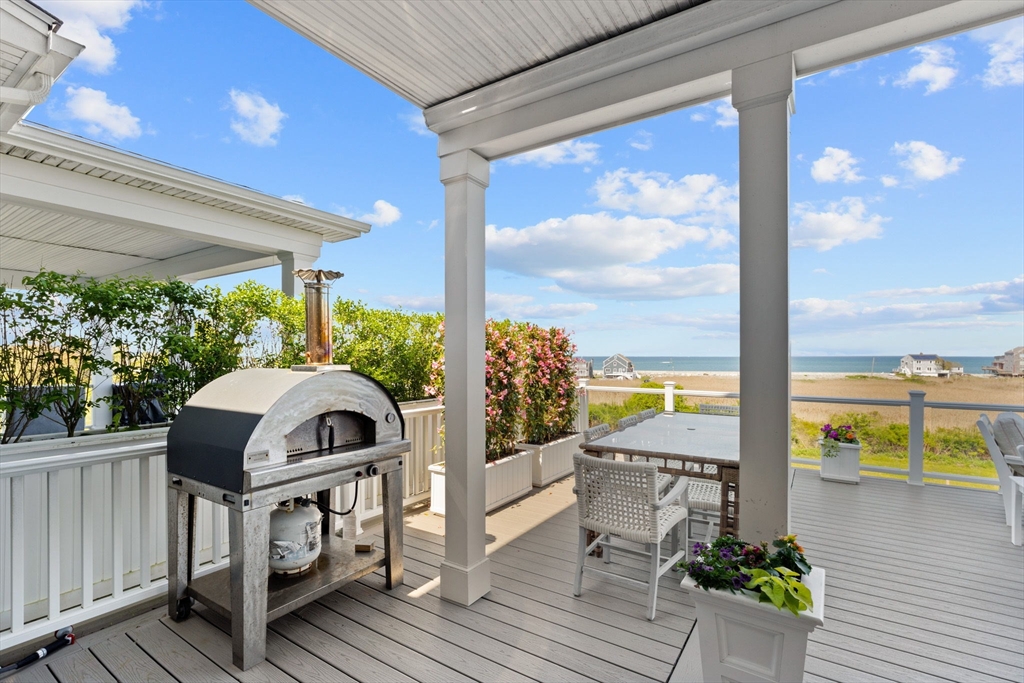 148 Hatherly Road, Unit 148 Scituate, MA 02066 - Photo 17 of 42 a view of balcony with floor to ceiling windows with wooden floor