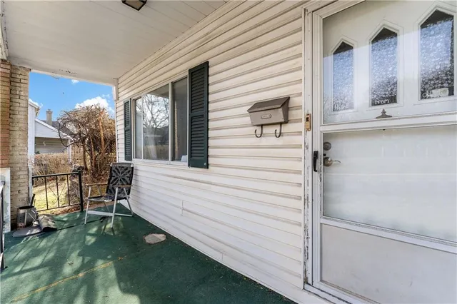 a view of a storage room with water heater and refrigerator