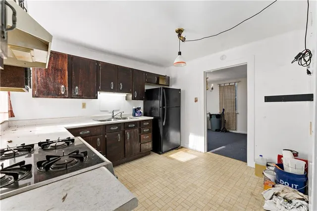 a kitchen with stainless steel appliances a stove a sink and a refrigerator