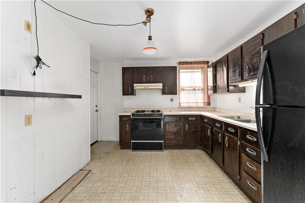 308 Merrimac Street Pittsburgh, PA 15211 - Photo 7 of 43 a kitchen with stainless steel appliances granite countertop a refrigerator a sink dishwasher a stove with wooden floor