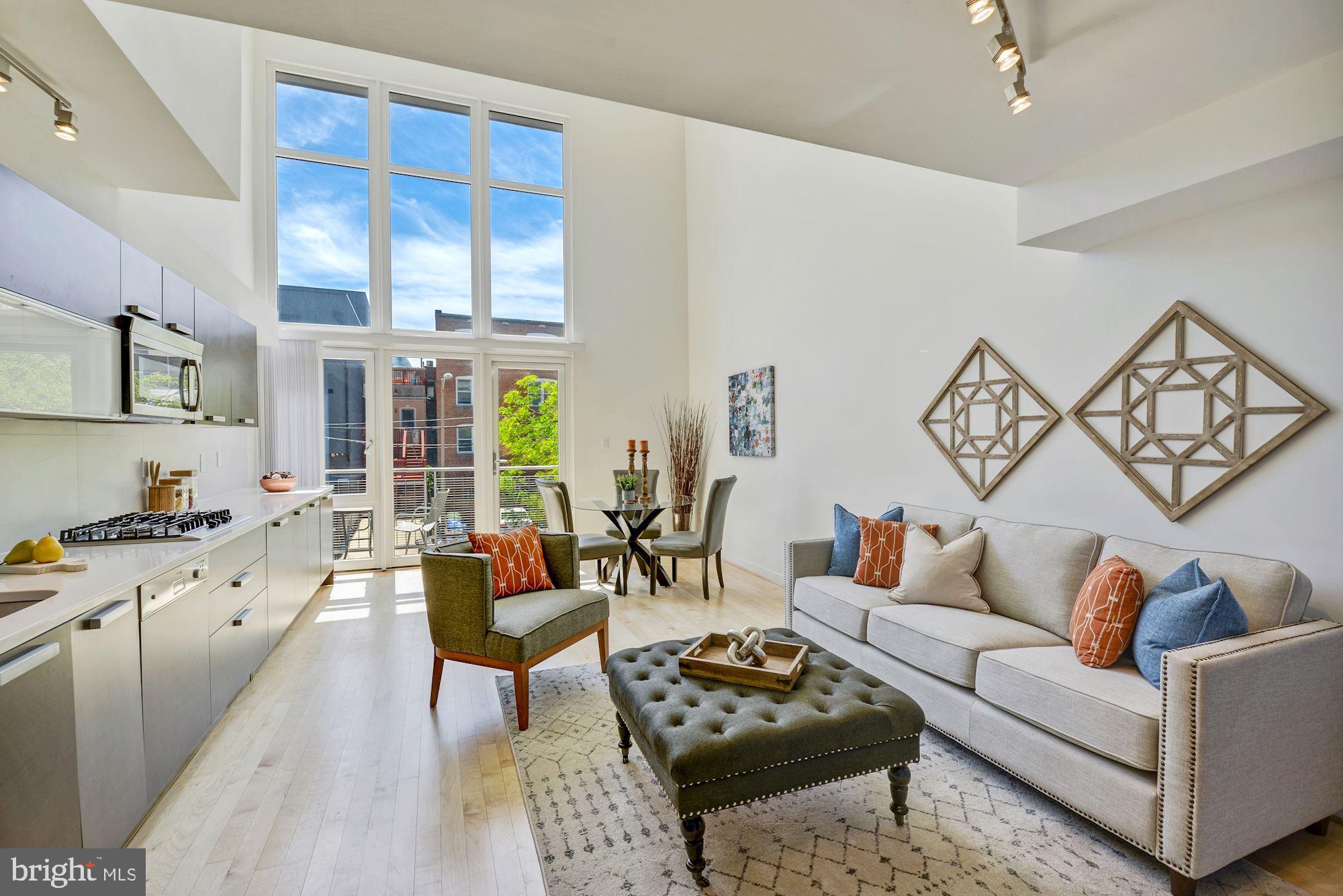 1466 Harvard Street Northwest, Unit A2 Washington, DC 20009 - Photo 1 of 21 a living room with furniture wooden floor and a large window