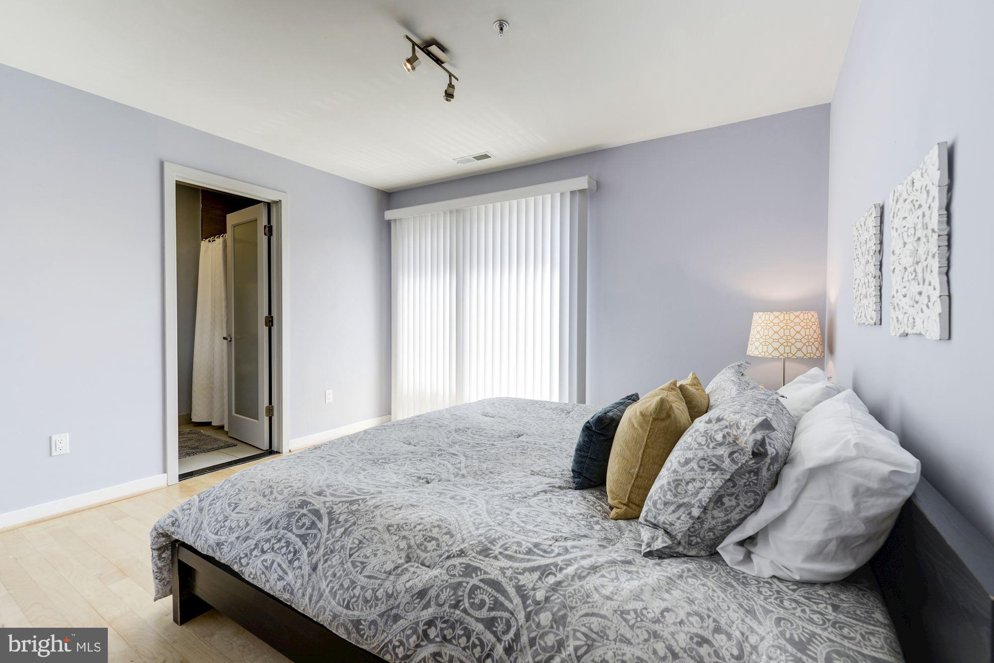 1466 Harvard Street Northwest, Unit A2 Washington, DC 20009 - Photo 12 of 21 a bedroom with a bed and a window