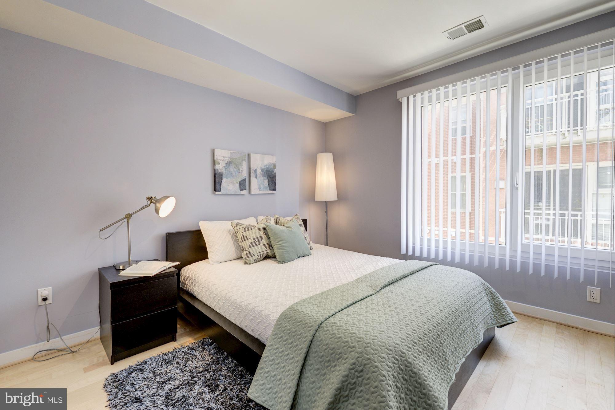 1466 Harvard Street Northwest, Unit A2 Washington, DC 20009 - Photo 15 of 21 a bedroom with a bed and a lamp