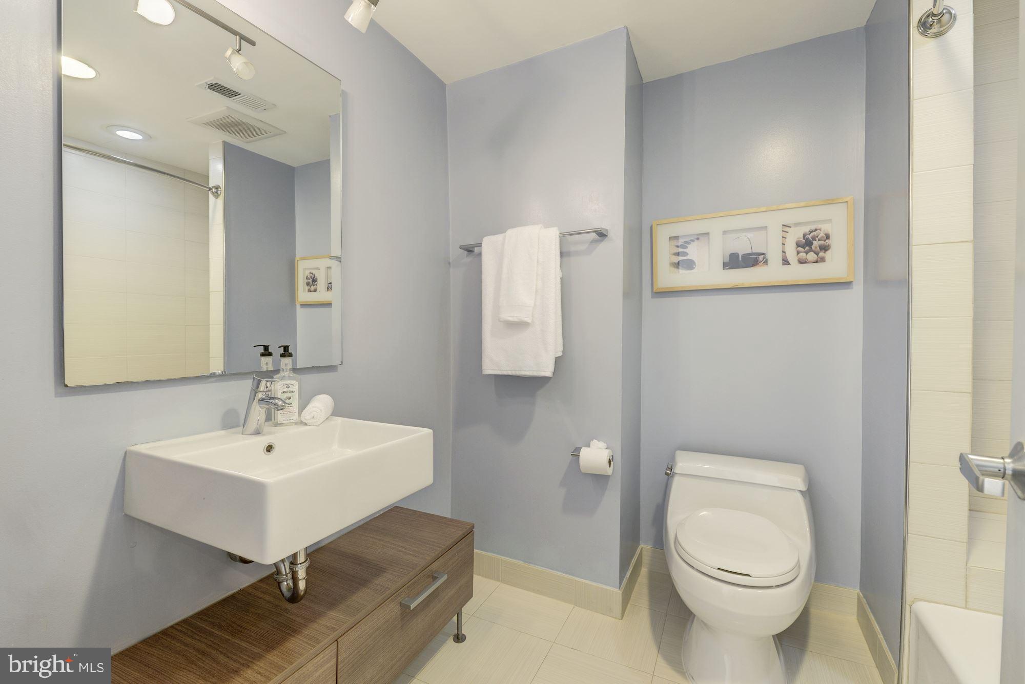 1466 Harvard Street Northwest, Unit A2 Washington, DC 20009 - Photo 16 of 21 a white toilet sitting next to a bathroom sink