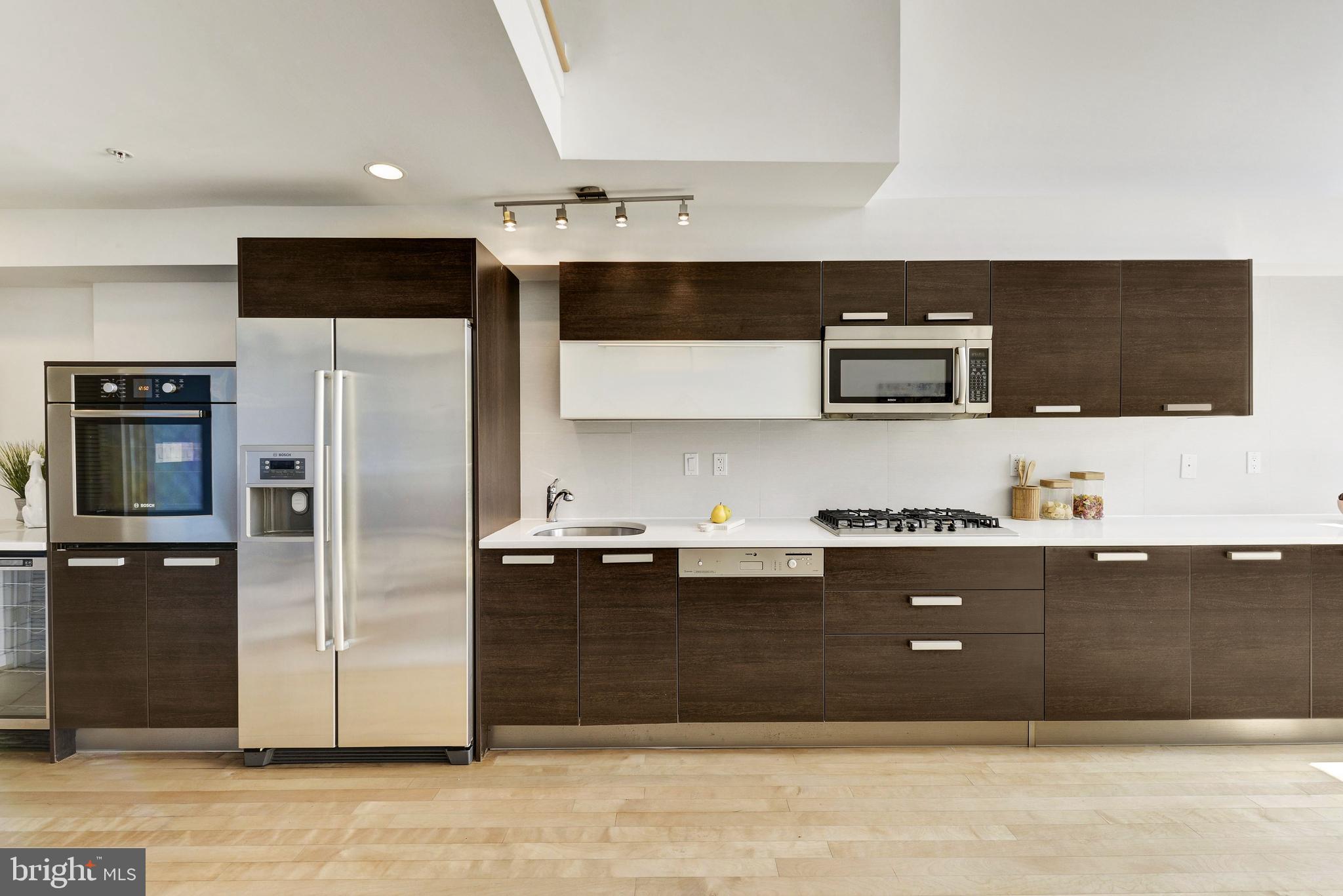 1466 Harvard Street Northwest, Unit A2 Washington, DC 20009 - Photo 4 of 21 a kitchen with stainless steel appliances kitchen island granite countertop a refrigerator and a sink