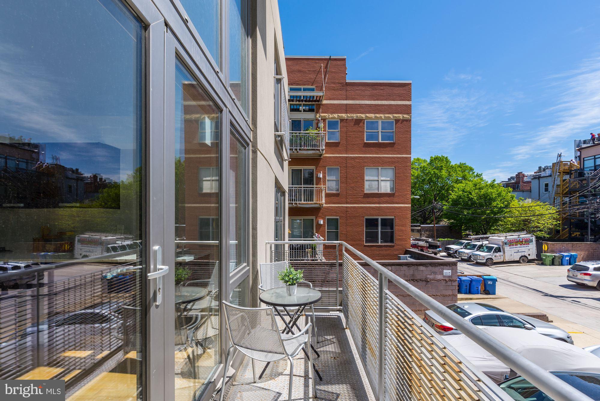 1466 Harvard Street Northwest, Unit A2 Washington, DC 20009 - Photo 5 of 21 a balcony with table and chairs