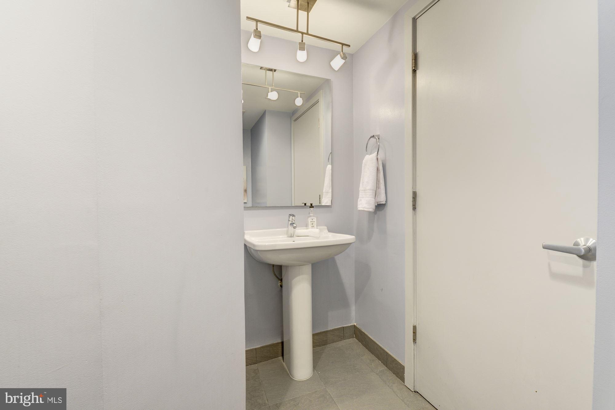 1466 Harvard Street Northwest, Unit A2 Washington, DC 20009 - Photo 7 of 21 a bathroom with a sink a mirror and a shower