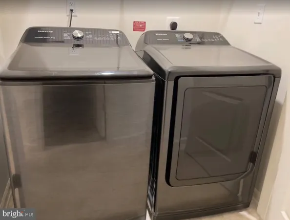 a utility room with a sink and washing machine