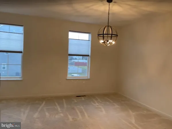 a room with window and a chandelier