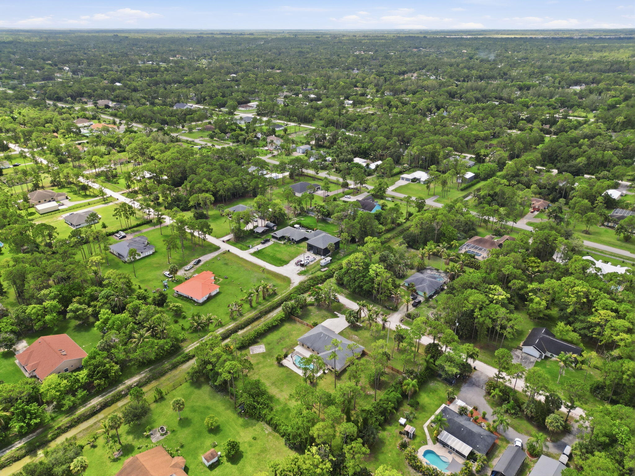 15731 85th Road North Loxahatchee, FL 33470 - Photo 60 of 65 an aerial view of residential houses with outdoor space and street view