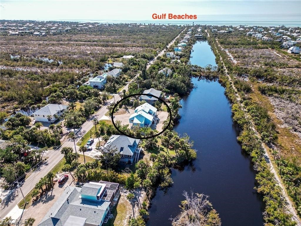 785 Rabbit Road Sanibel, FL 33957 - Photo 30 of 32 an aerial view of a house with a yard and lake view in back