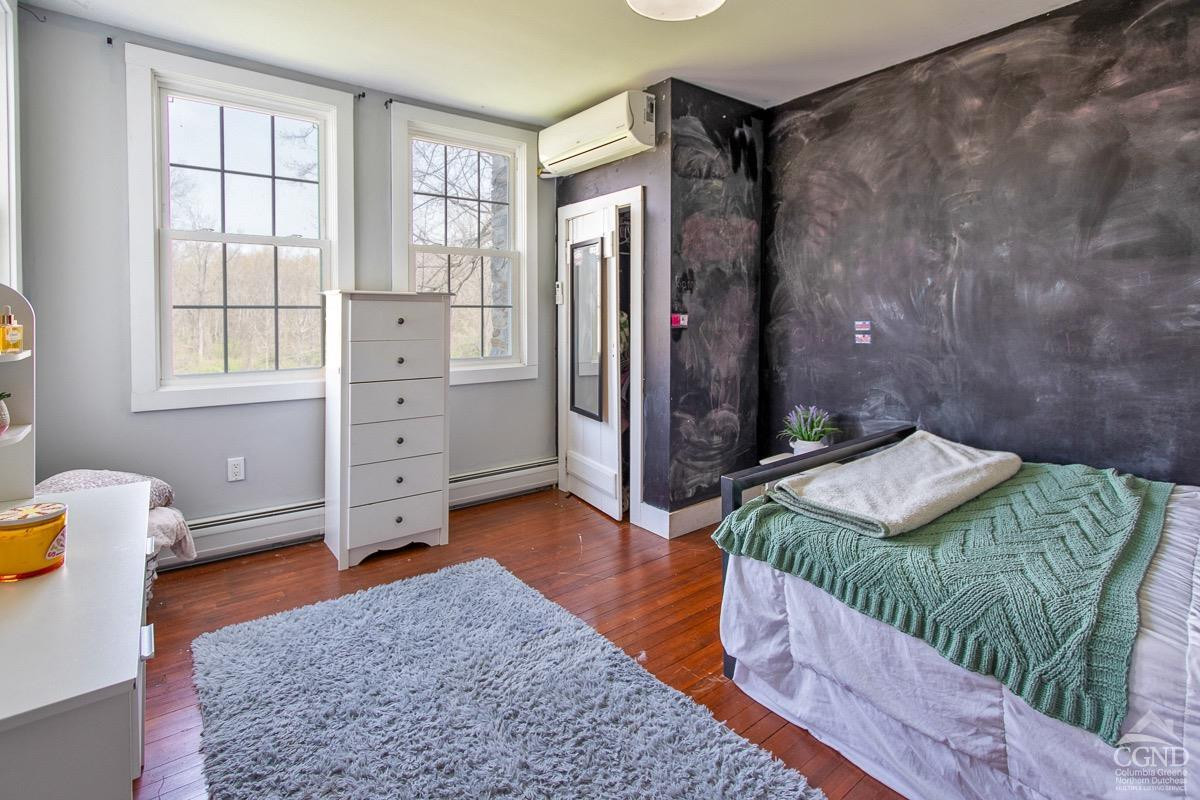 0 3327 Route 199 Pine Plains, NY 12567 - Photo 28 of 43 a bedroom with a bed and wooden floor