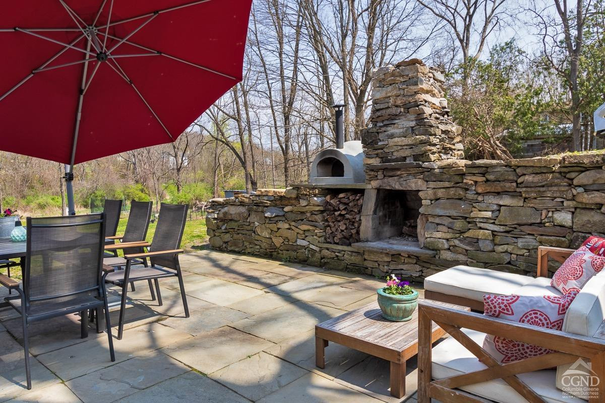0 3327 Route 199 Pine Plains, NY 12567 - Photo 33 of 43 a patio with a table and chairs under an umbrella