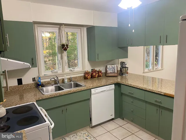 a kitchen with a stove a sink and a microwave