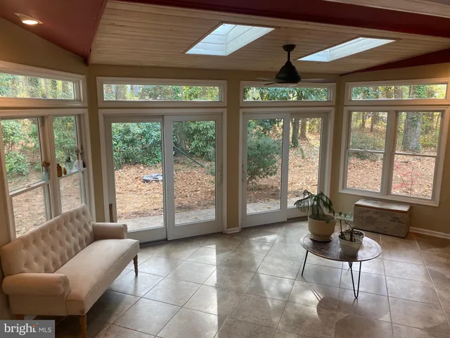 a living room with furniture and large windows