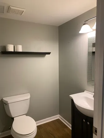 a bathroom with a toilet a sink and vanity