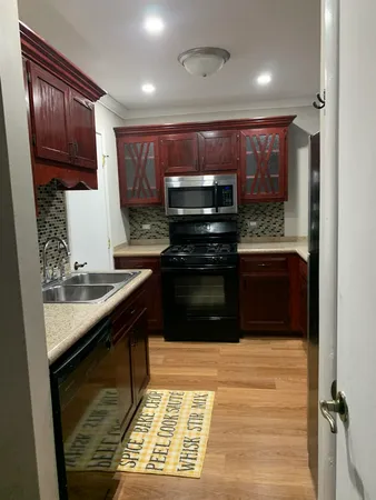 a kitchen with stainless steel appliances granite countertop a stove and a sink