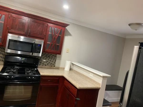 a kitchen with a stove and a microwave