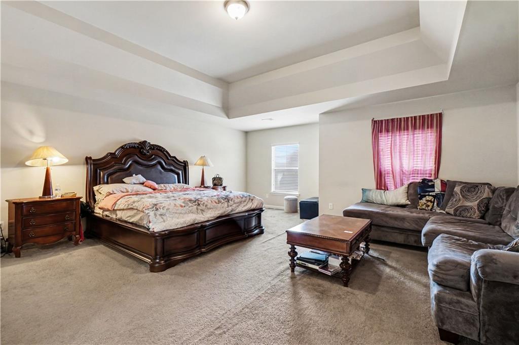 4157 Sublime Trail Atlanta, GA 30349 - Photo 12 of 20 a bedroom with a bed and furniture
