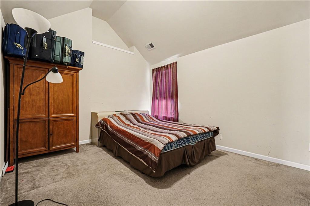 4157 Sublime Trail Atlanta, GA 30349 - Photo 17 of 20 a bed sitting in a room next to a cabinet